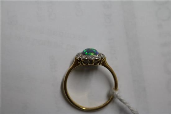 An 18ct gold and platinum, black opal and diamond cluster oval ring, size L.